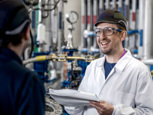 Curia lab worker talking with another team member