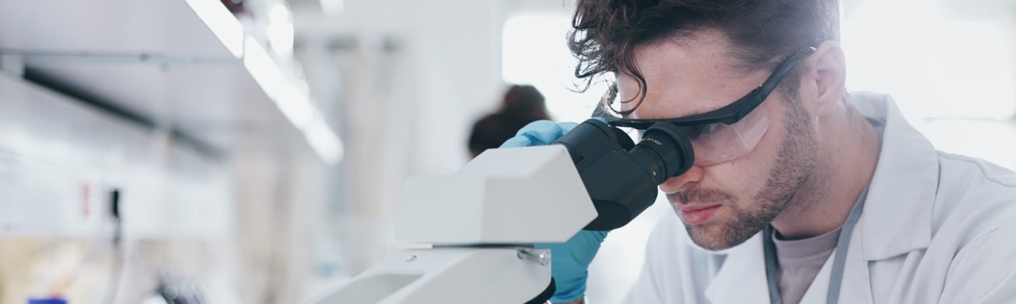 Man looking into microscope